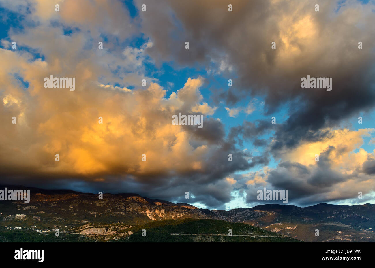 Panoramic landscape of sky and rocks near Budva riviera. Fantastic view of the overcast sky. Dramatic sunset scene. Balkans, Adriatic sea, Europe. Stock Photo