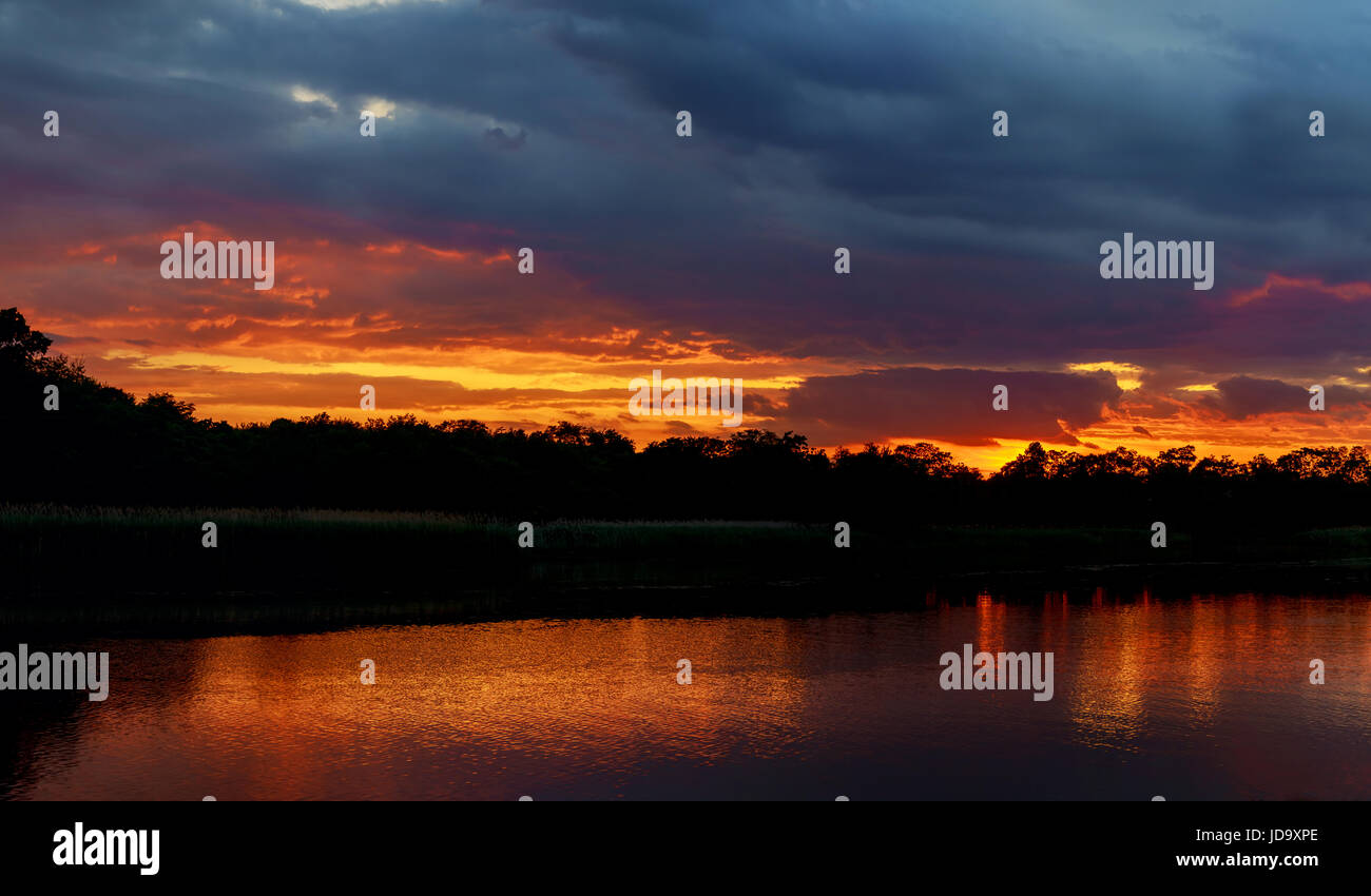 sunset in the river with reflex sunset on the river Stock Photo - Alamy