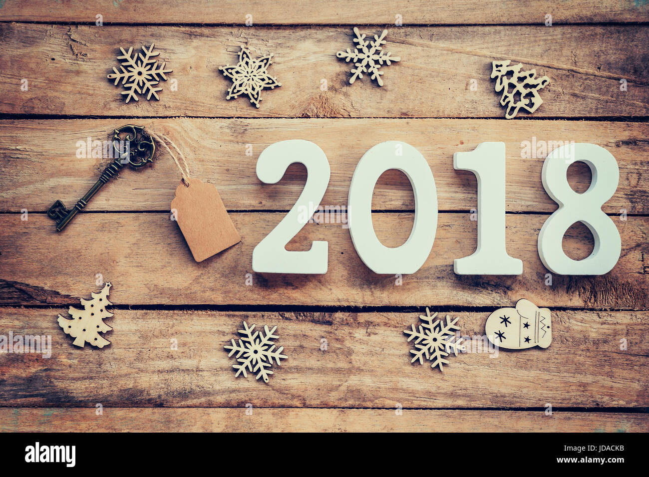 Old key with tag and wooden numbers forming the number 2018, For the new year 2018 on a rustic wooden background. Stock Photo