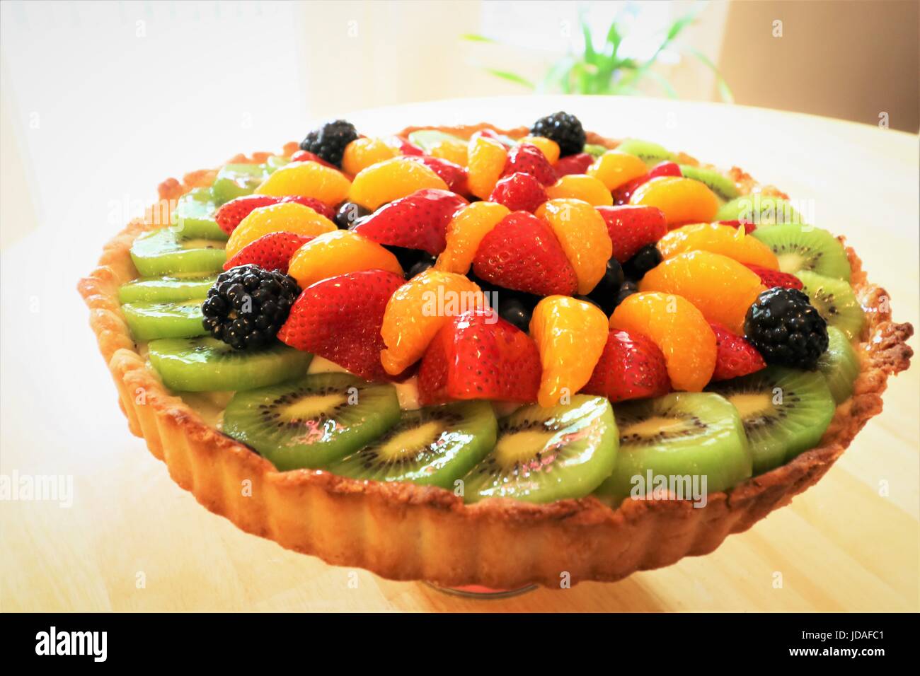 fresh summer fruit tart with shortbread cookie crust, layered with dark chocolate, Kahlua flavored crème patisserie, and fresh fruit Stock Photo