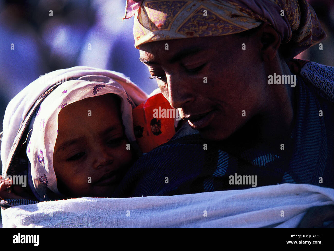 An Ethiopian woman carrying her young child. Stock Photo