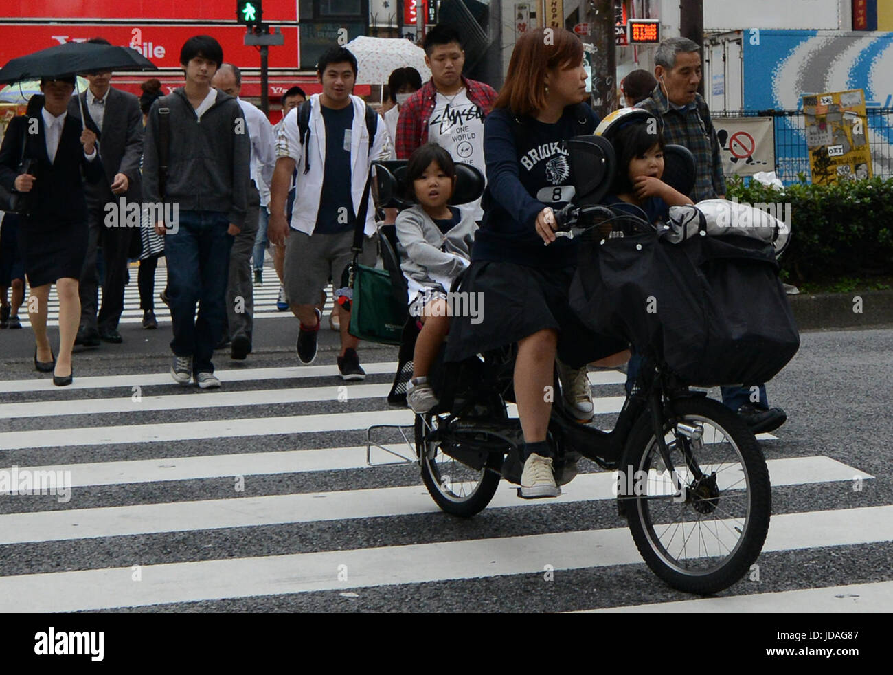 A Japanese mother riding her bicycle with her children Stock Photo Alamy