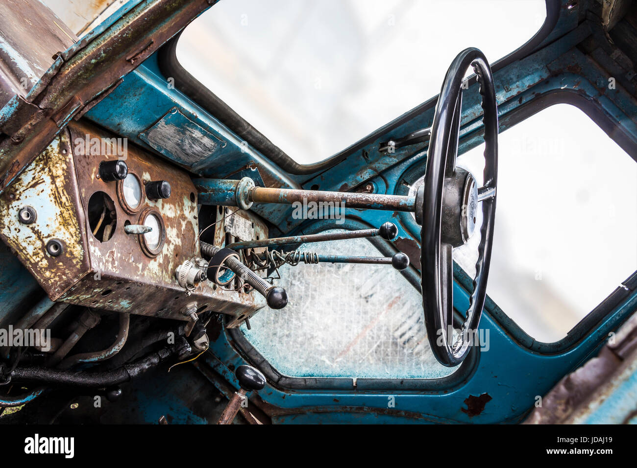 The instrument panel and steering wheel of the old rusty abandoned