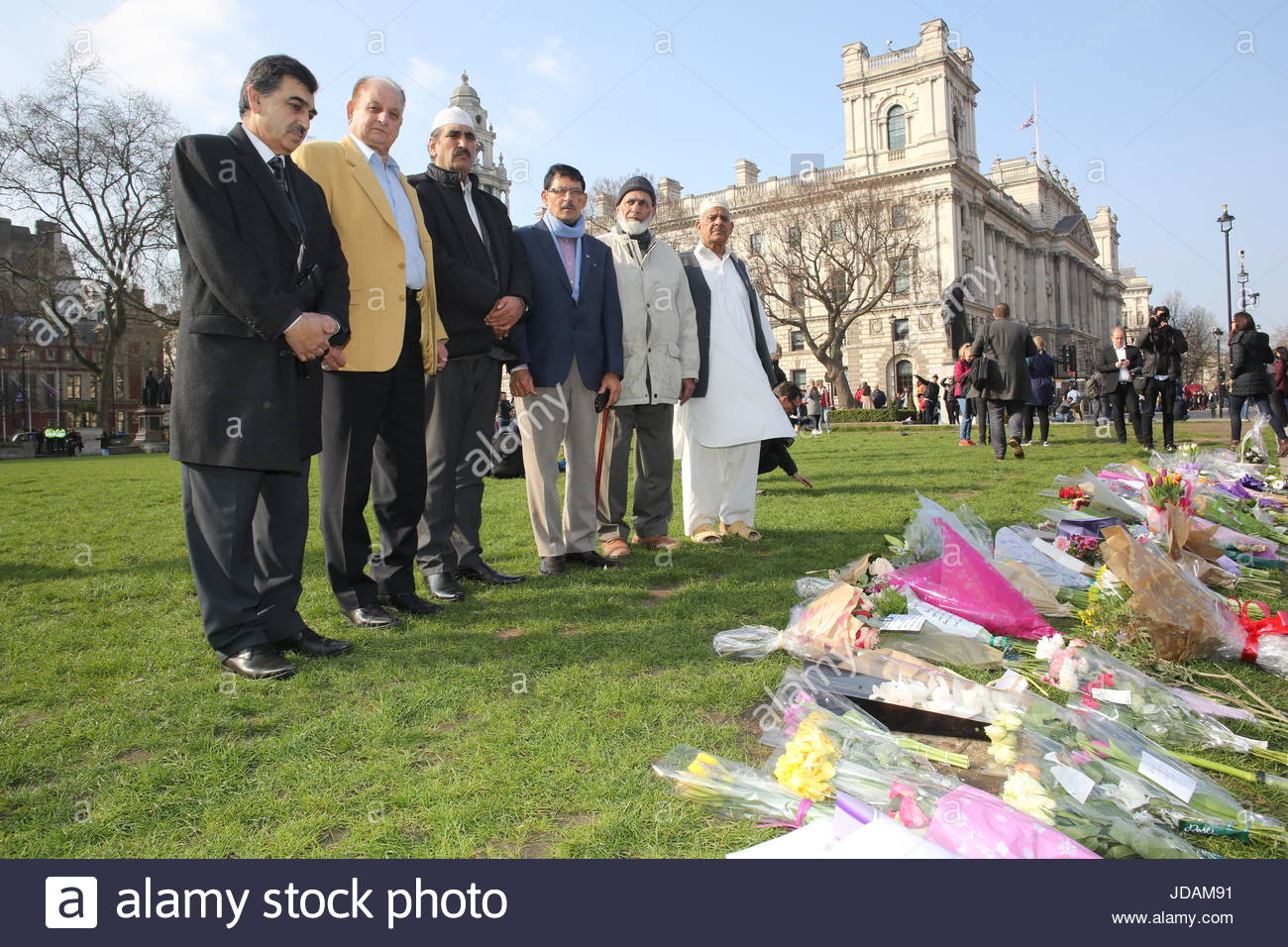 At a floral tribute to the victims of the London Brdige attack leaders from the Muslim community pay their respects to those killed and injured. Stock Photo