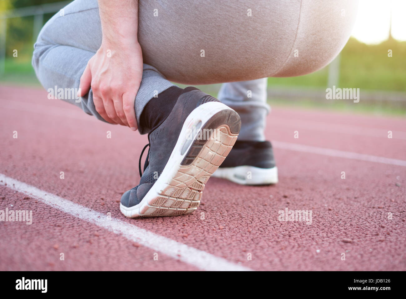 Running athlete feeling pain after an ankle injury Stock Photo Alamy