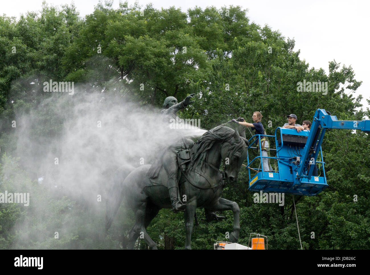 The statue of George Washington in Union Square Park getting its annual cleaning by a Parks Dept worker and an intern. Stock Photo