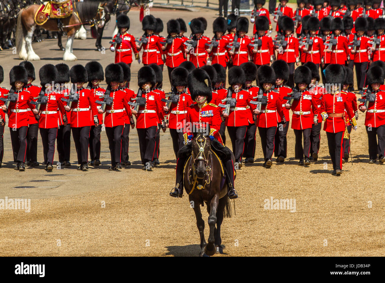 An officer on horseback leads The Irish Guards as they march on Horse Guards Parade at Trooping The Colour, London, UK , 2017 Stock Photo