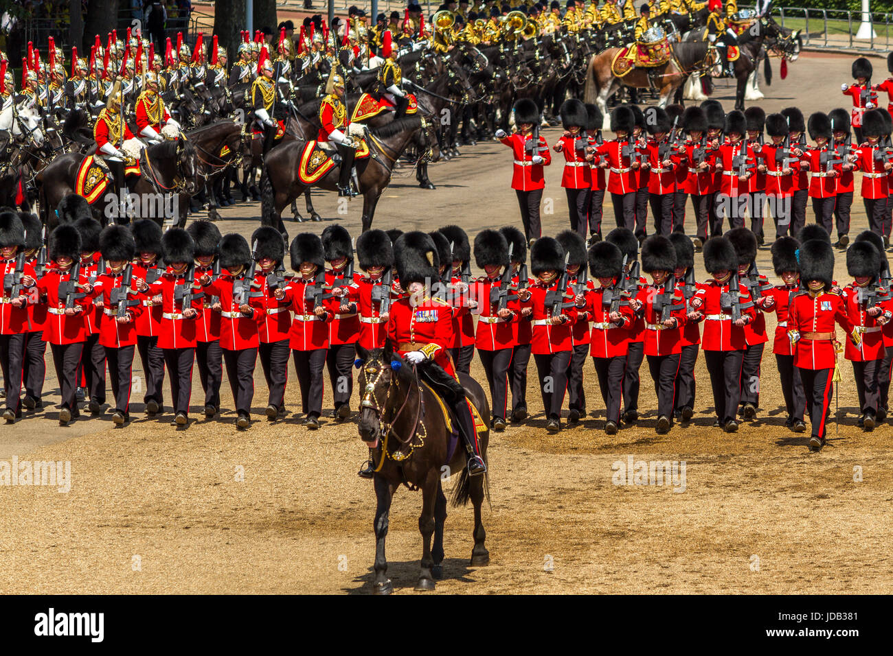 An officer on horseback leads The Irish Guards as they march on Horse Guards Parade at Trooping The Colour, London, UK , 2017 Stock Photo