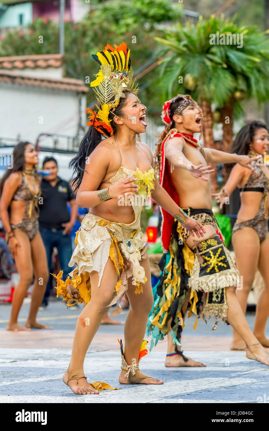 Banos De Agua Santa, Ecuador - 29 November 2014: Group Of Traditional Huaorani People Performing Folk Dance On The Streets Of Banos De Agua Santa Stock Photo