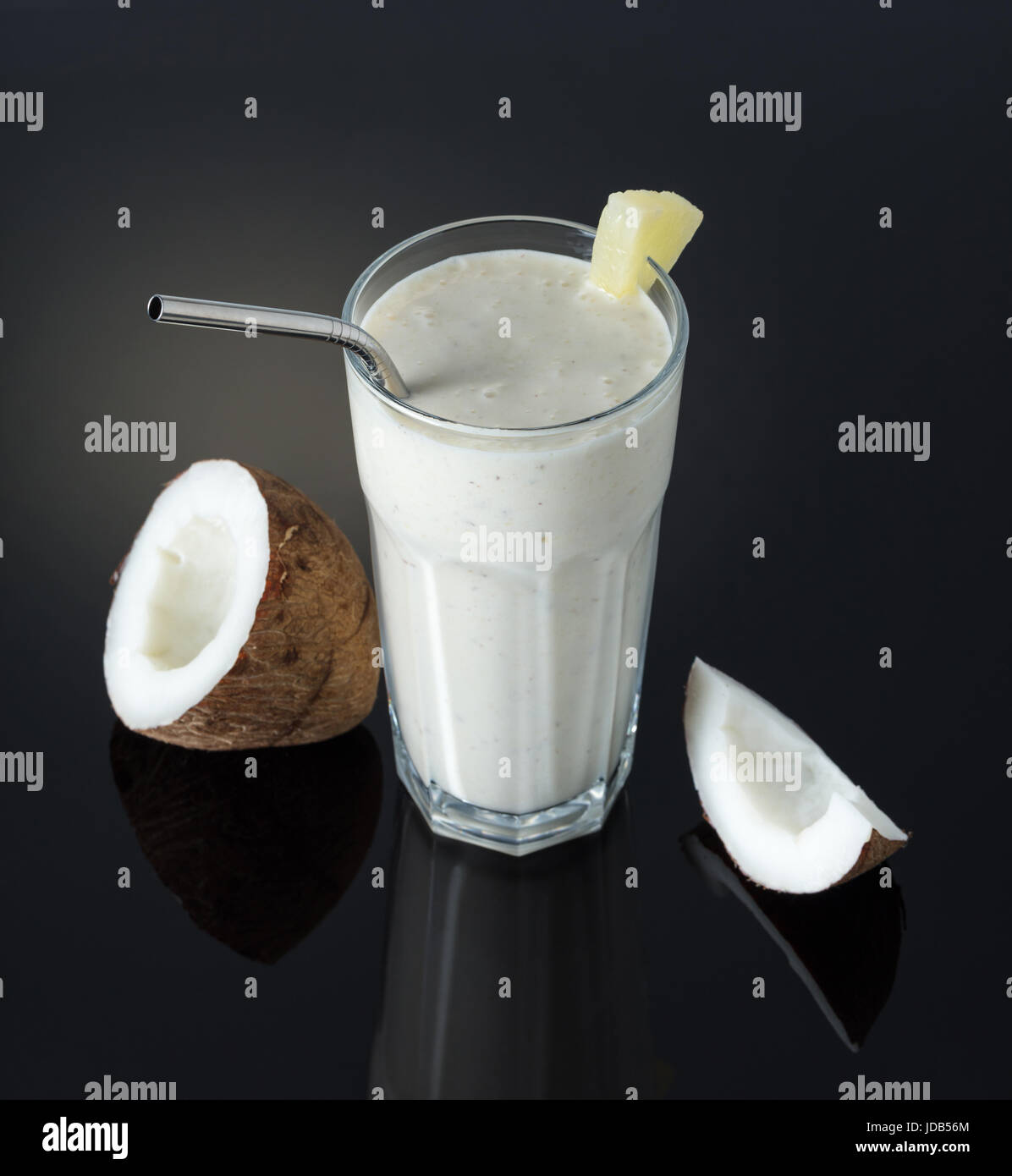 Milkshake with coconut and pineapple on a black background Stock Photo