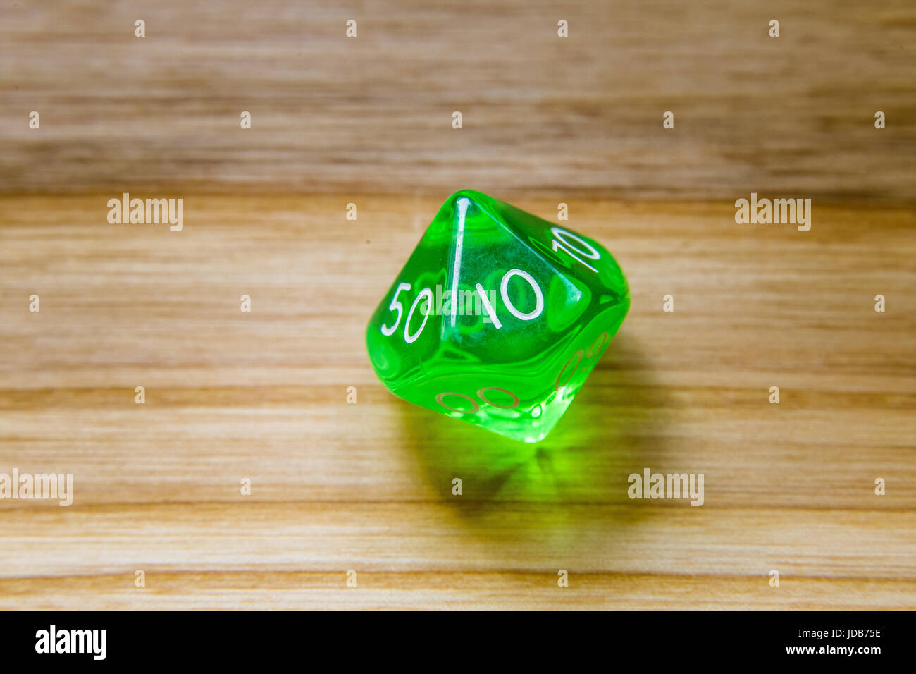 A beautiful winning playing dice rolled on a side on wooden table Stock Photo Alamy