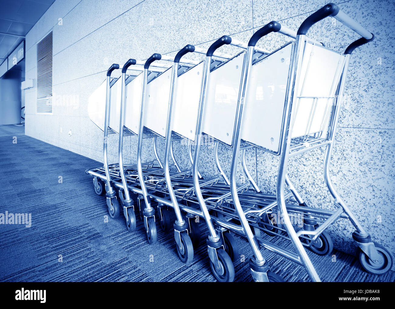 Luggage carts inside modern international airport Stock Photo Alamy