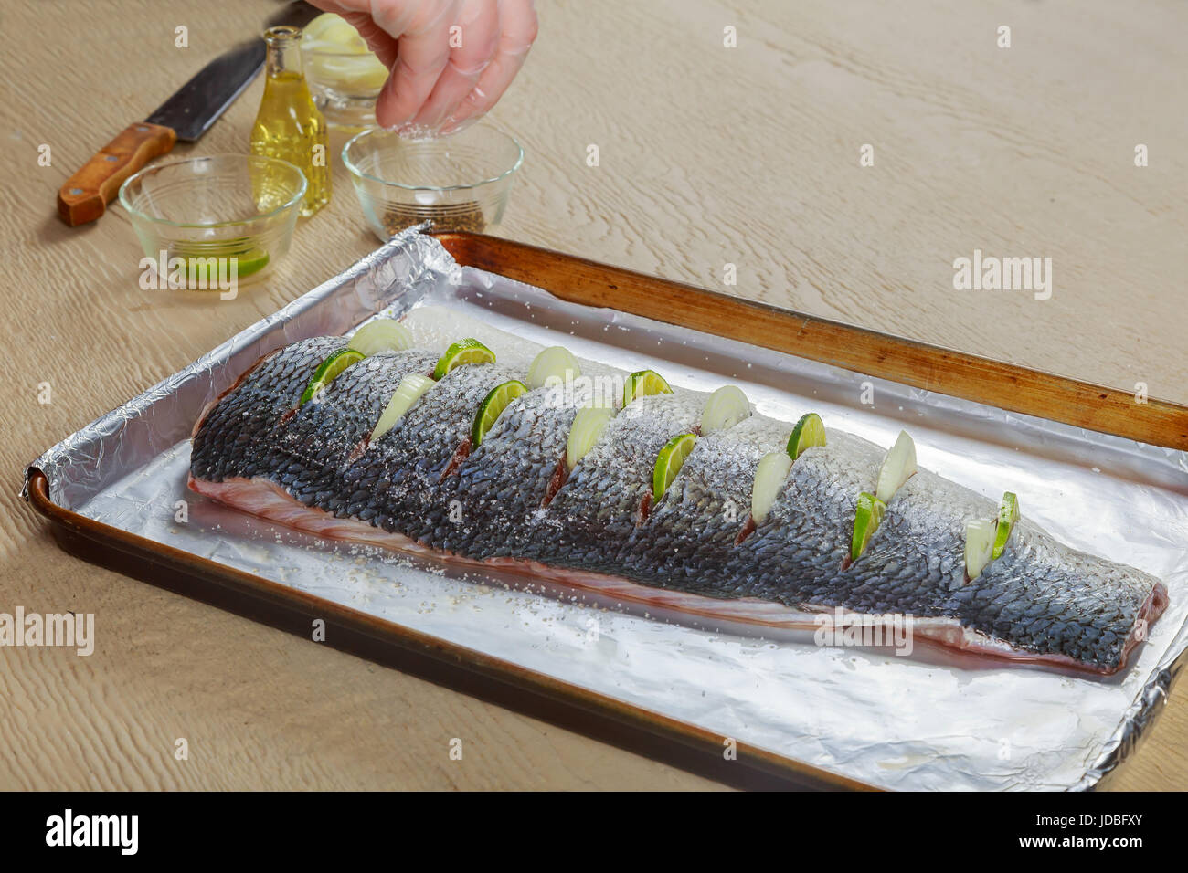 marinated fish with lemon and onion dish in the oven Stock Photo Alamy