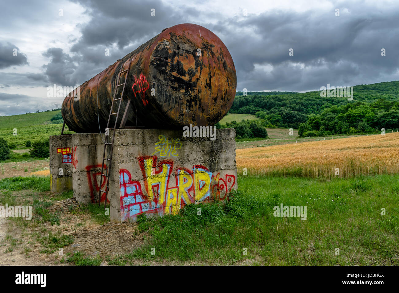 Nature scenery with contrast of the old rusty water tank. Male Kozmalovce, Slovakia 20th of june 2017 Stock Photo