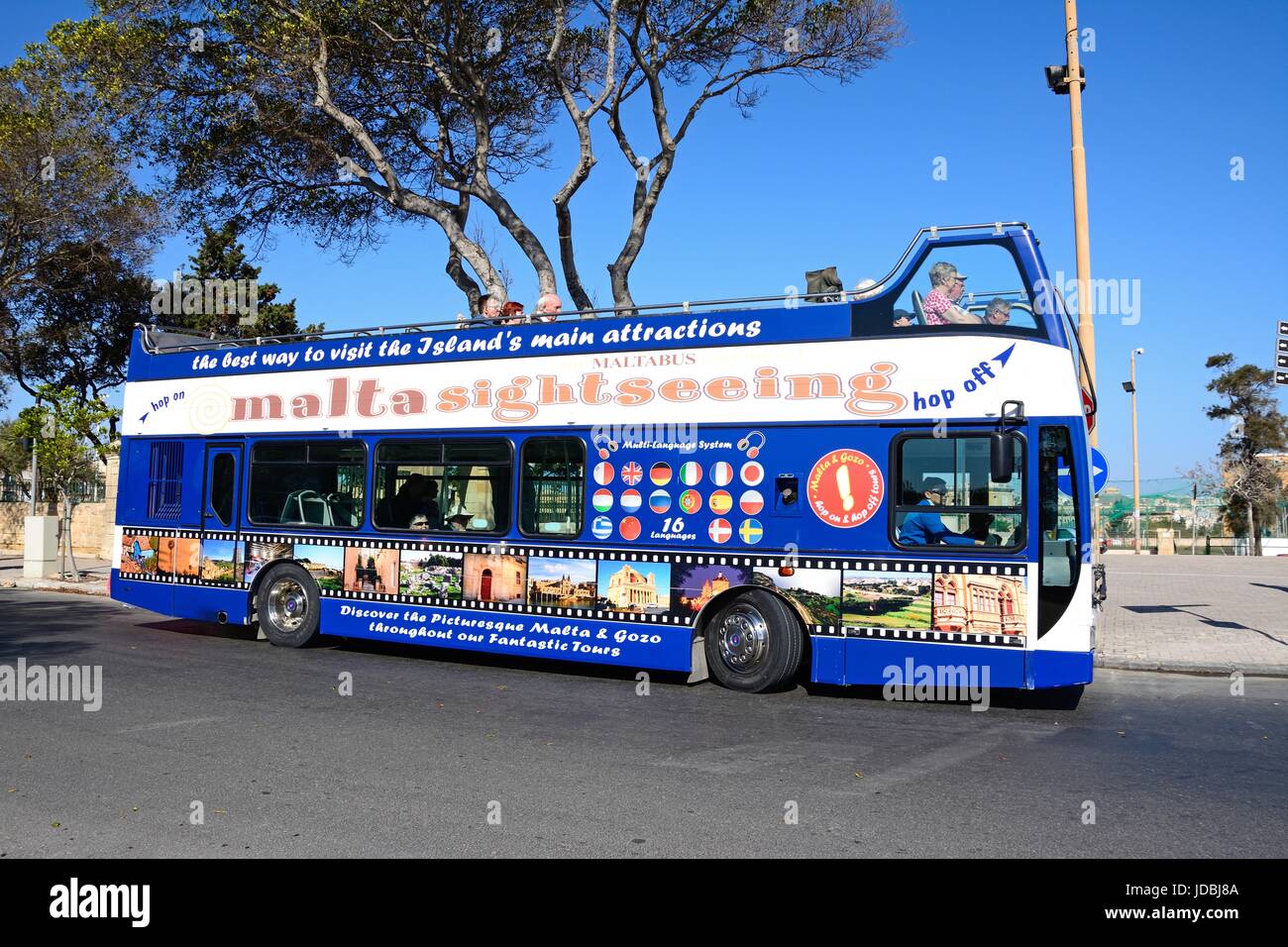 Passengers aboard a bus open topped tour bus, Floriana, Malta, Europe. Stock Photo