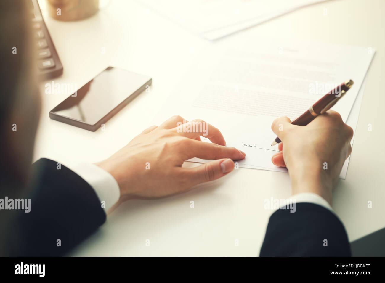 businesswoman putting signature on business partnership contract Stock Photo