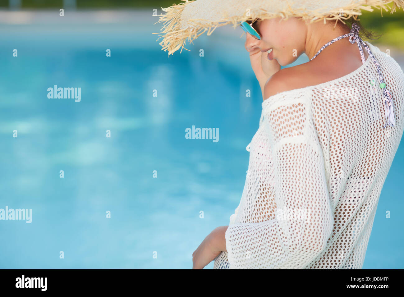 Young woman sun bathing in spa resort swiming pool Stock Photo