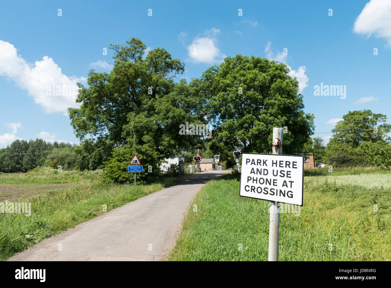 Level crossing request sign before railway crossing Stock Photo Alamy