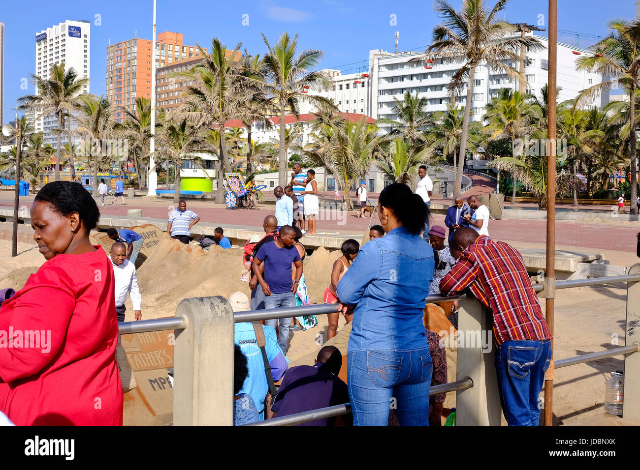 Durban South Africa. African tourists watching the local sand sculptors