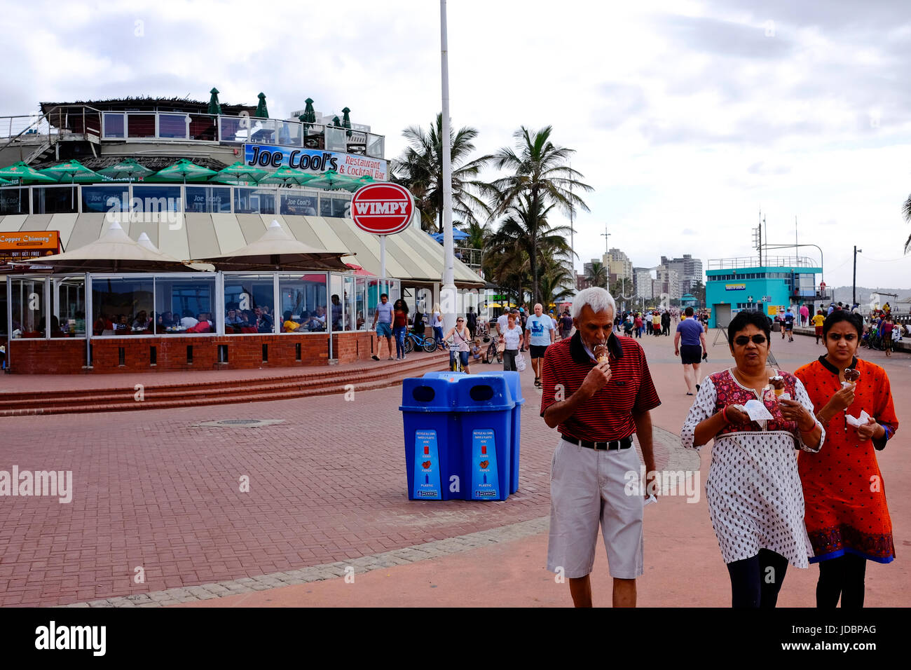 Durban South Africa. Restaurants along the Durban beachfront. Asian family walks along the