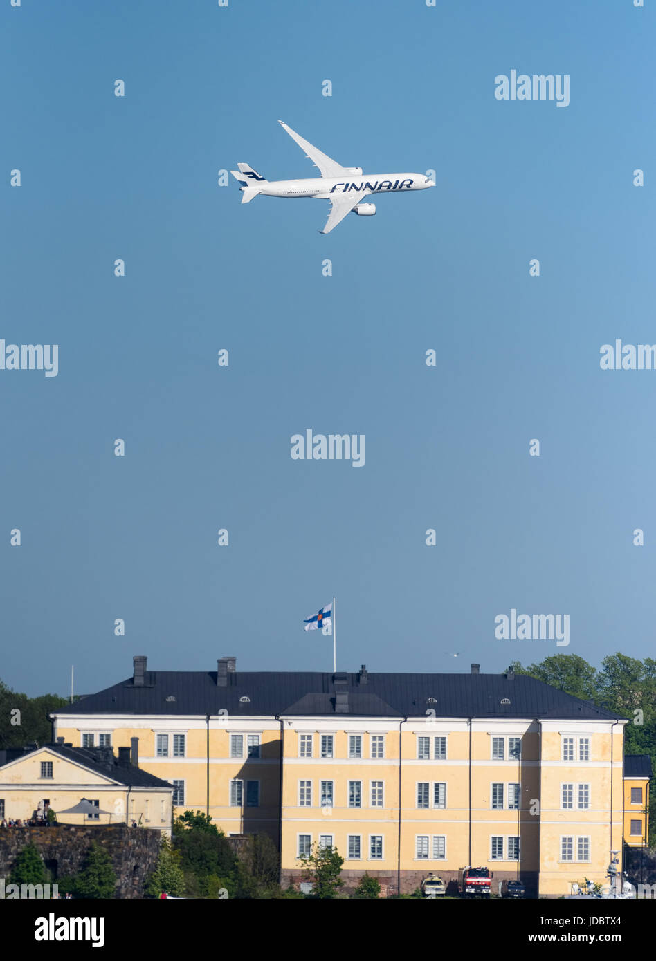 Helsinki, Finland - 9 June 2017: Finnair Airbus A350 XWB airliner flying in extremely low altitude over Suomenlinna fortress island at the Kaivopuisto Stock Photo