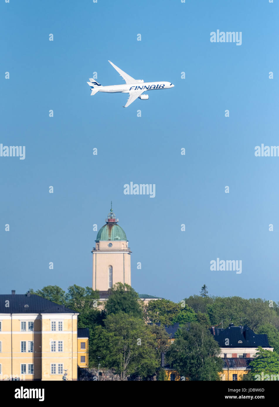 Helsinki, Finland - 9 June 2017: Finnair Airbus A350 XWB airliner flying in extremely low altitude over Suomenlinna fortress island at the Kaivopuisto Stock Photo