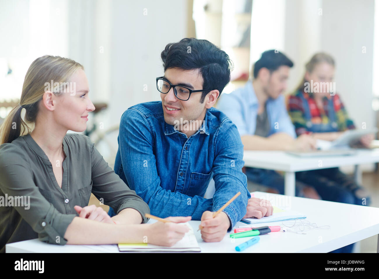 Creative young couple having talk at lesson Stock Photo