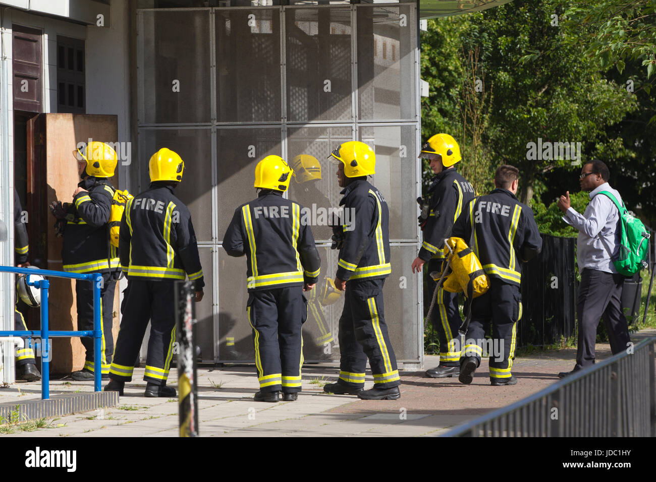 Fire Brigade officers search for a fire at Norland House, in White City nearby Grenfell Tower fire disaster, West London, UK Stock Photo