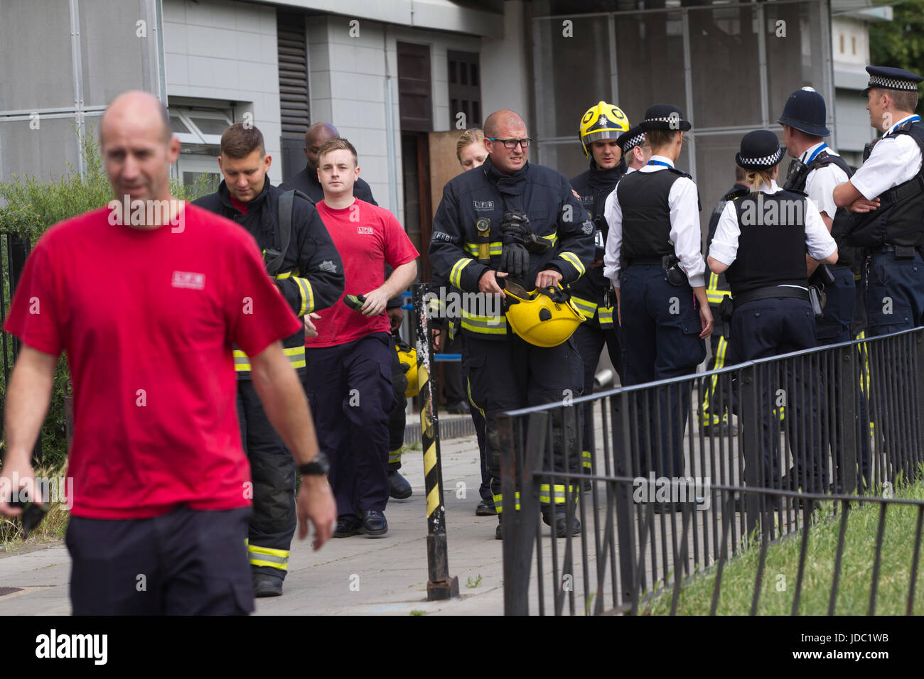 Fire Brigade officers search for a fire at Norland House, in White City nearby Grenfell Tower fire disaster, West London, UK Stock Photo