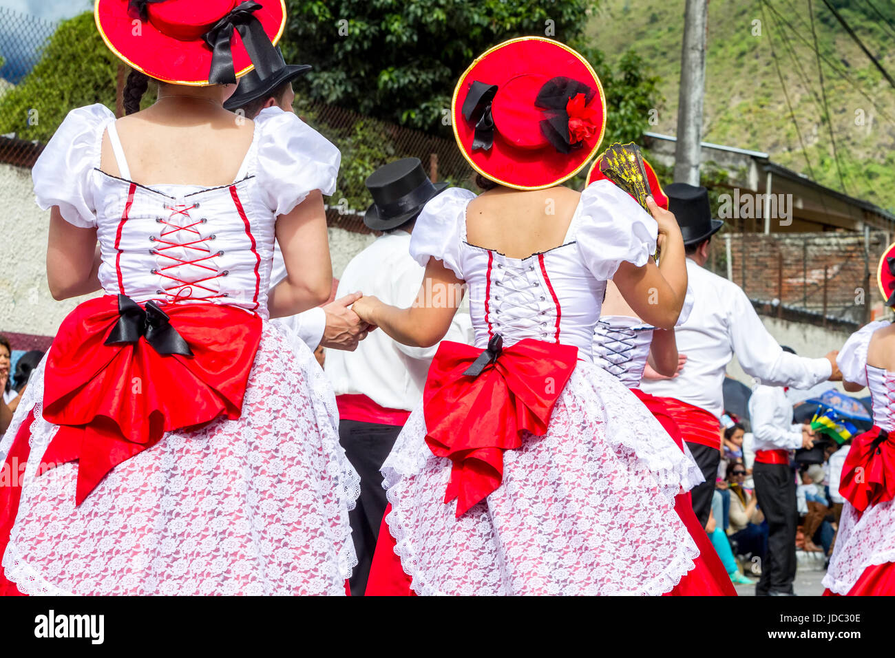 Group Of Hispanic People From Ecuador Is Dancing On The Streets Of Banos De Agua Santa, South America, Christmas Holiday Stock Photo