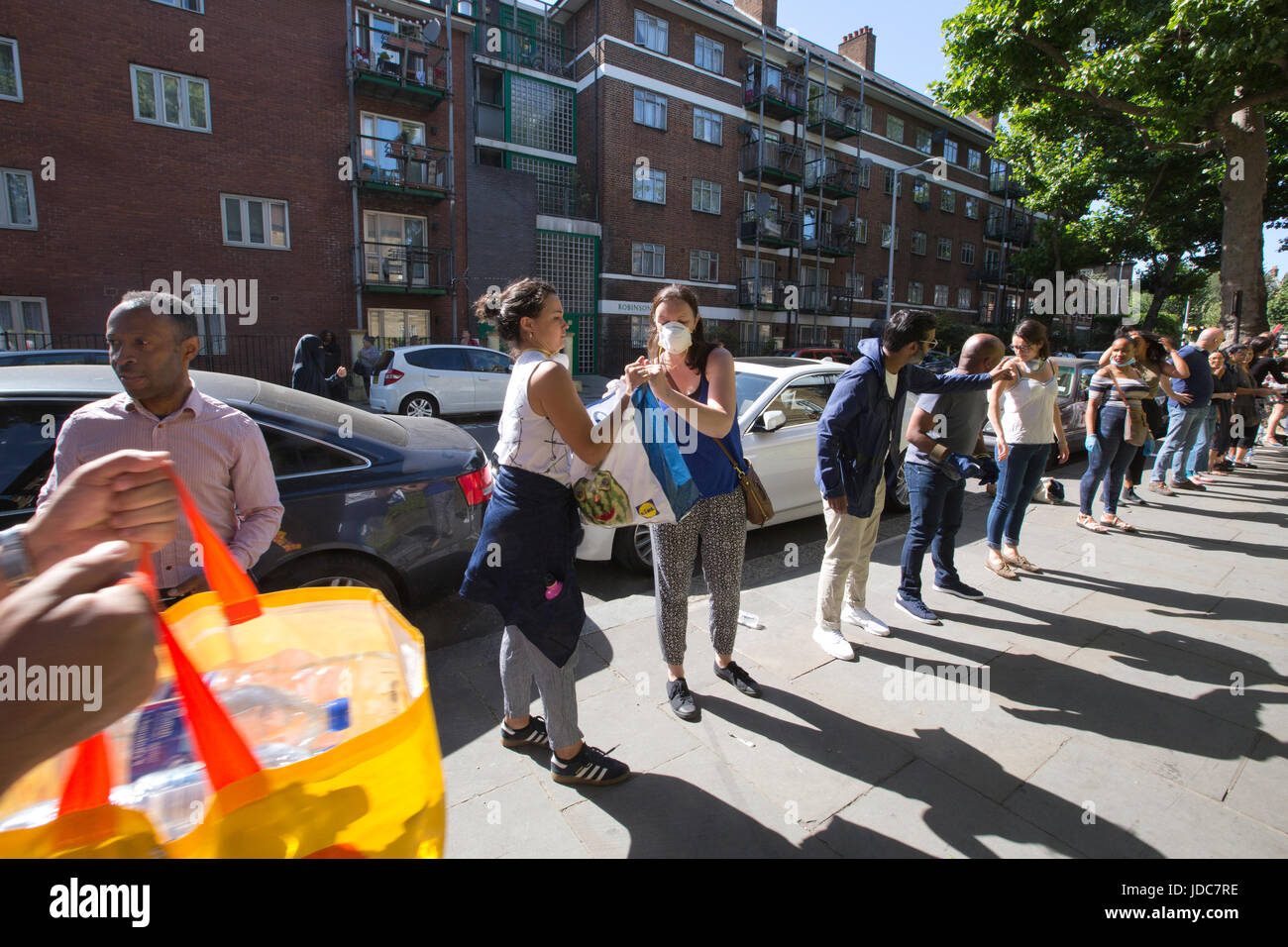 Local community dispensing food and clothes to help aid the victims left homeless after the Grenfell Tower fire disaster, West London, UK Stock Photo