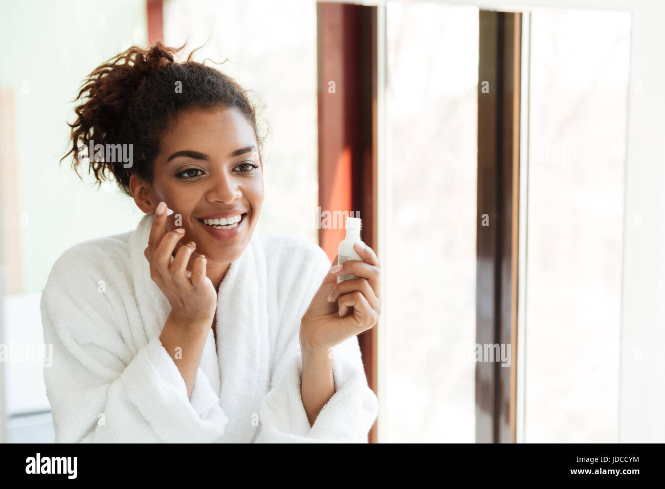Picture of happy young african lady standing indoors at home and ...