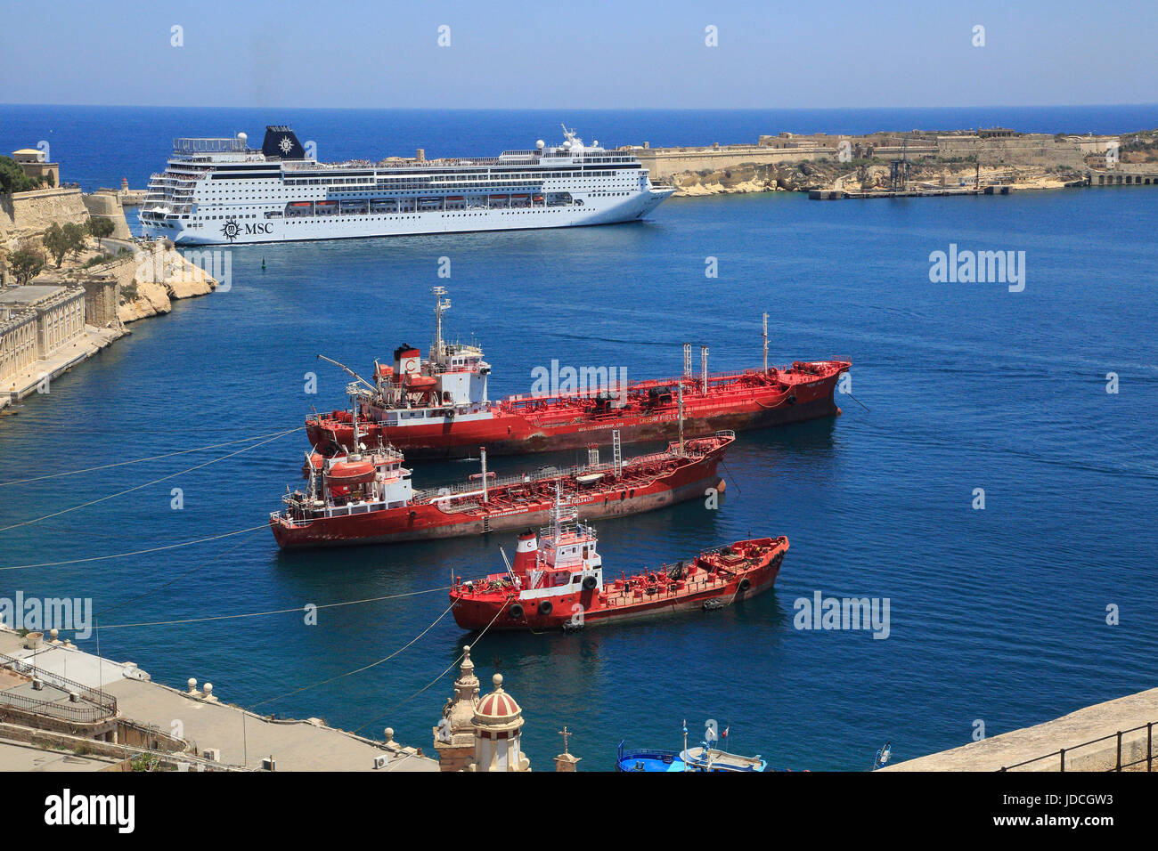 Merchant shipping and cruise ship arriving in Grand Harbour, Valletta, Malta Stock Photo