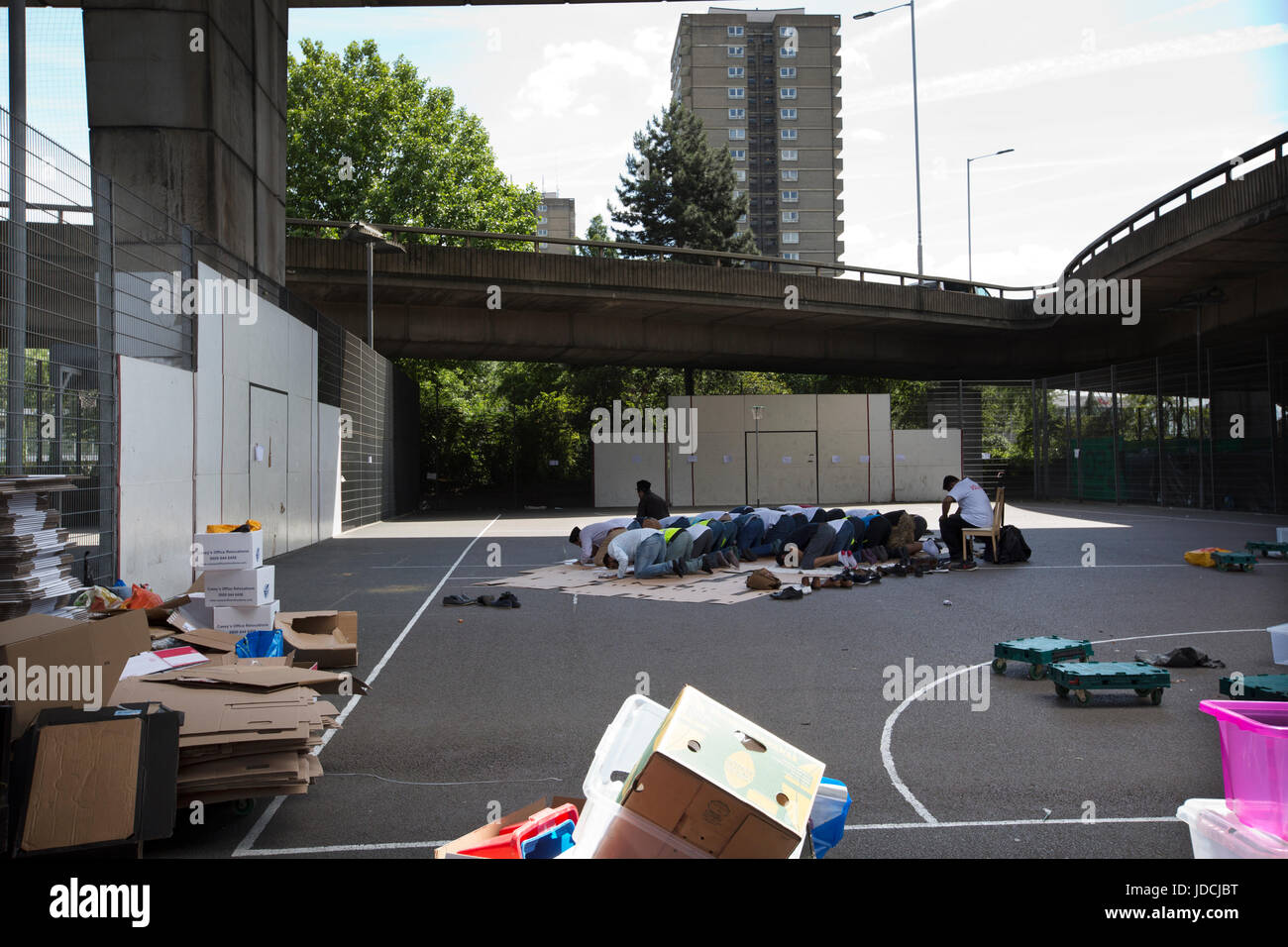 Members of the Islamic community left homeless after fire disaster praying nearby Grenfell Tower, in an area during Ramadan, West London, UK Stock Photo
