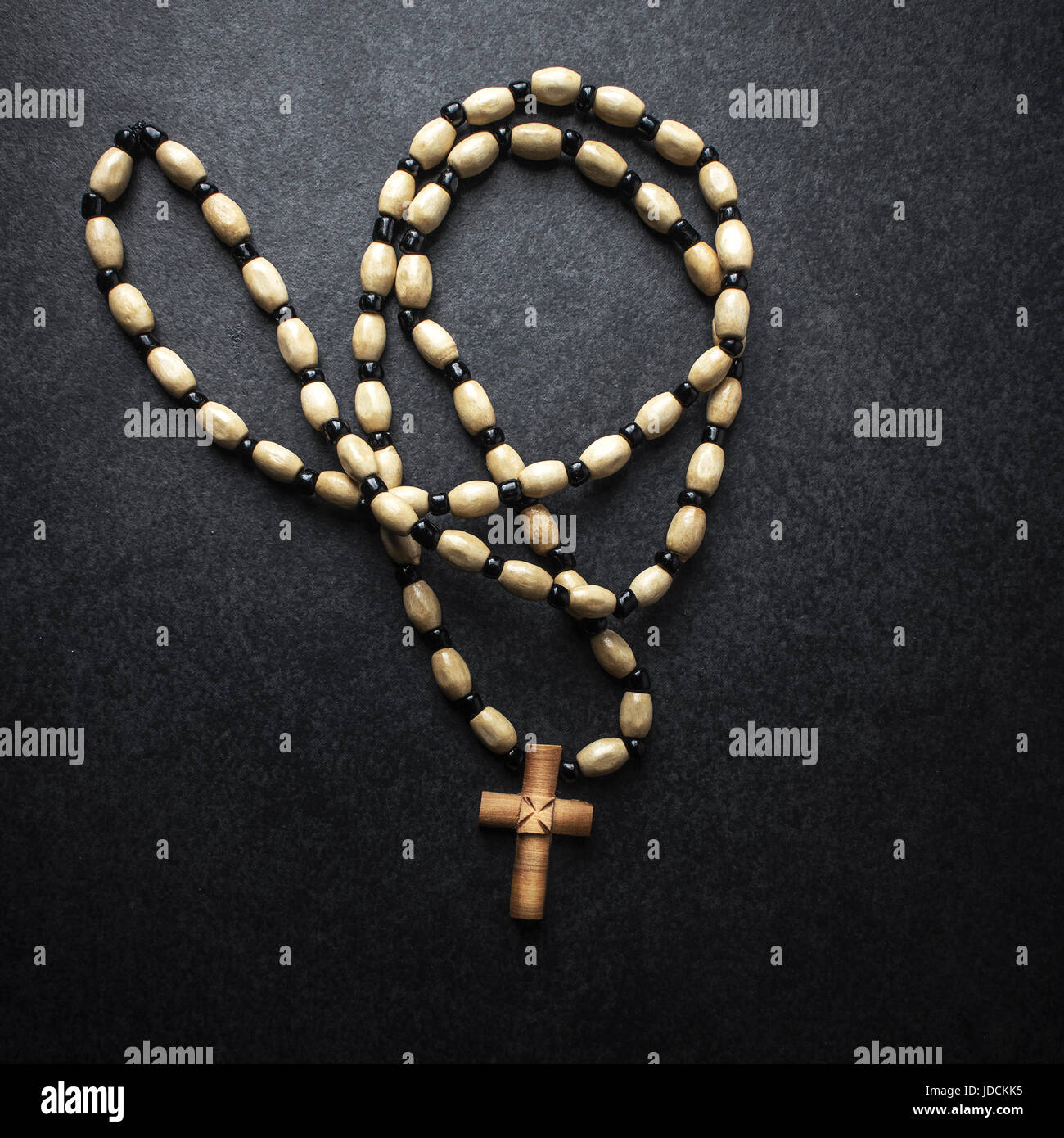 Rosary beads with cross made of wood, from above Stock Photo
