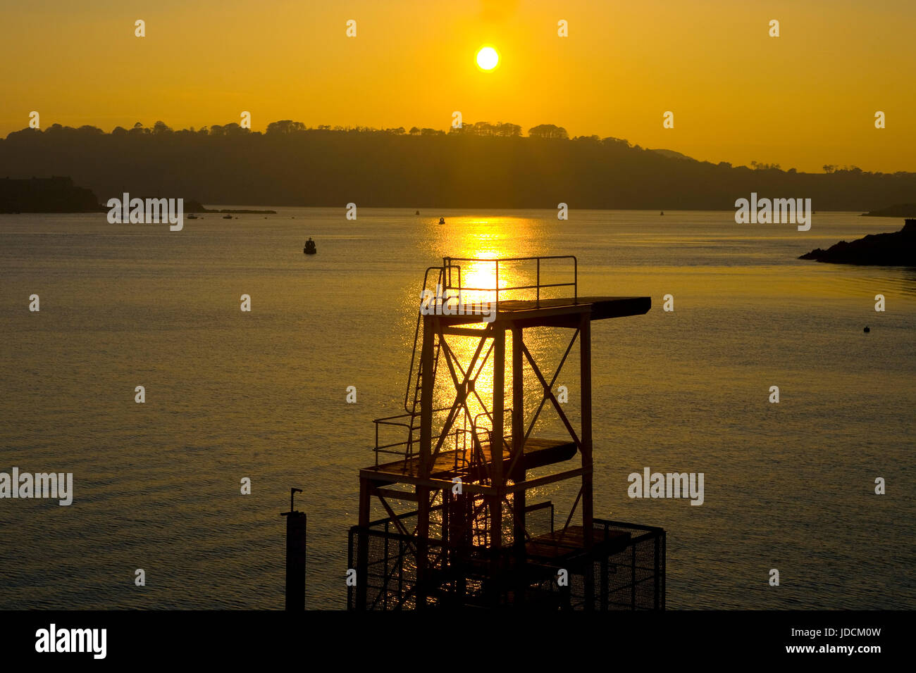diving board on Plymouth hoe with golden sunset in background with sea