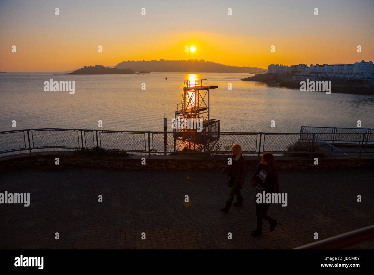 diving board on Plymouth hoe with golden sunset in background with sea