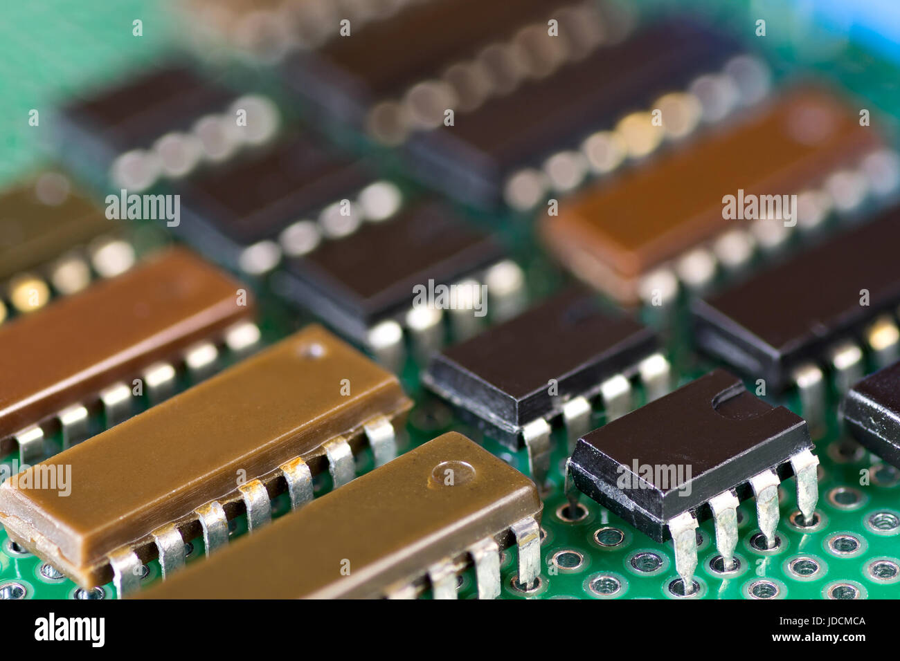 Rows of integral circuits on Printed Circuit Board close-up Stock Photo