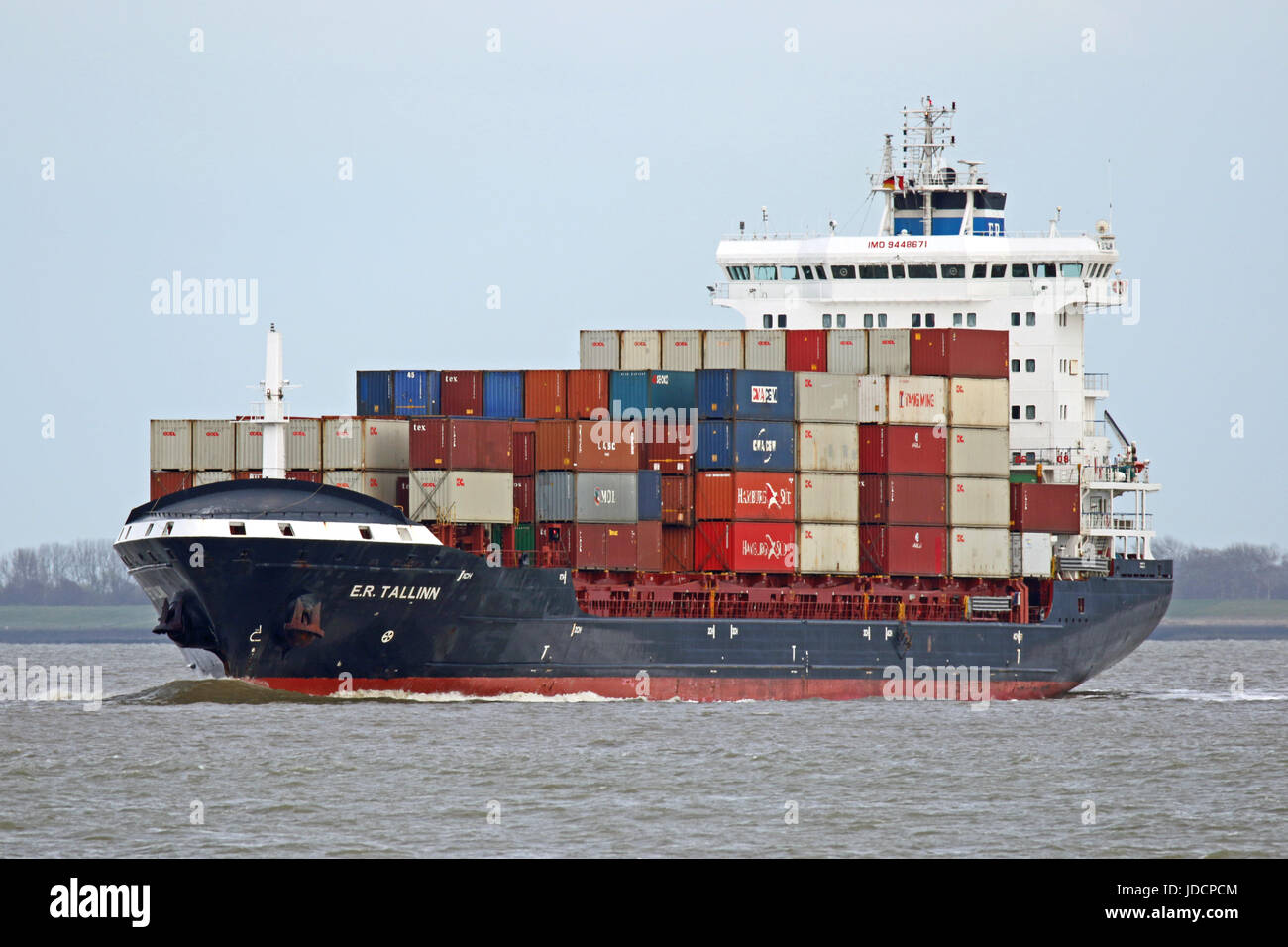 The container ship E.R. Tallinn on the schelde river passing Terneuzen on the way to the north sea. Stock Photo