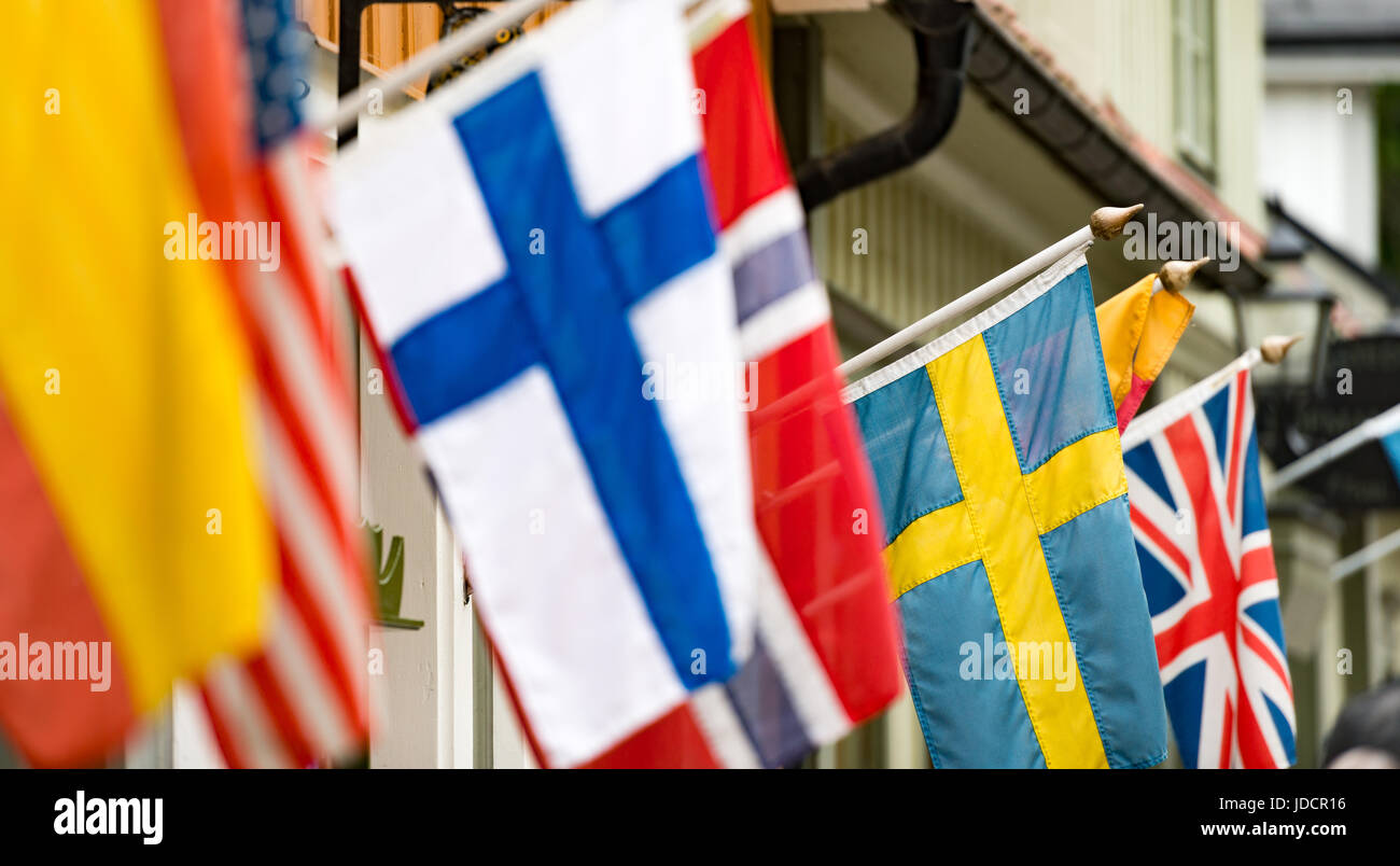 Many flags on wall of building in old town Sigtuna. Europe travel. Sweden, Scandinavia. Stock Photo