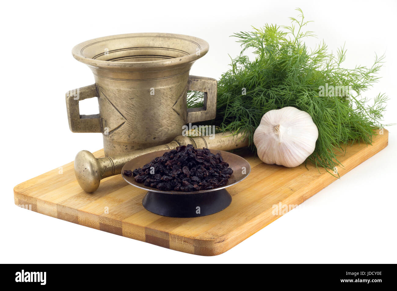 Still Life Spices,pepperidge ,marigold staminas in a copper vase on a wooden board on a background of a stern stupa for grinding spices, bunches of di Stock Photo