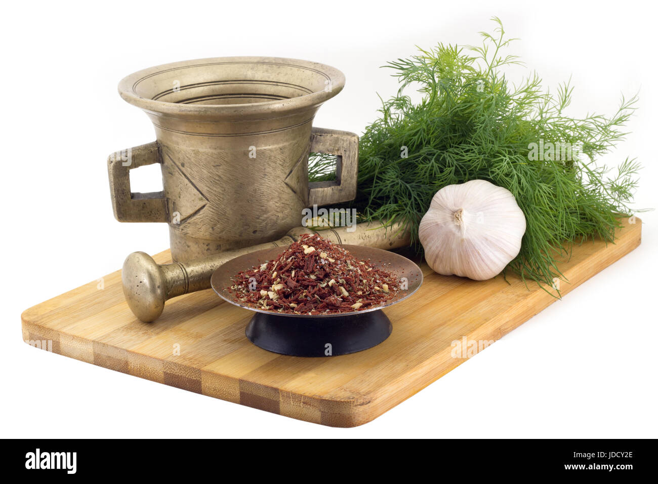 Still Life Spices, mix voor bruschetta,marigold staminas in a copper vase on a wooden board on a background of a stern stupa for grinding spices, bunc Stock Photo