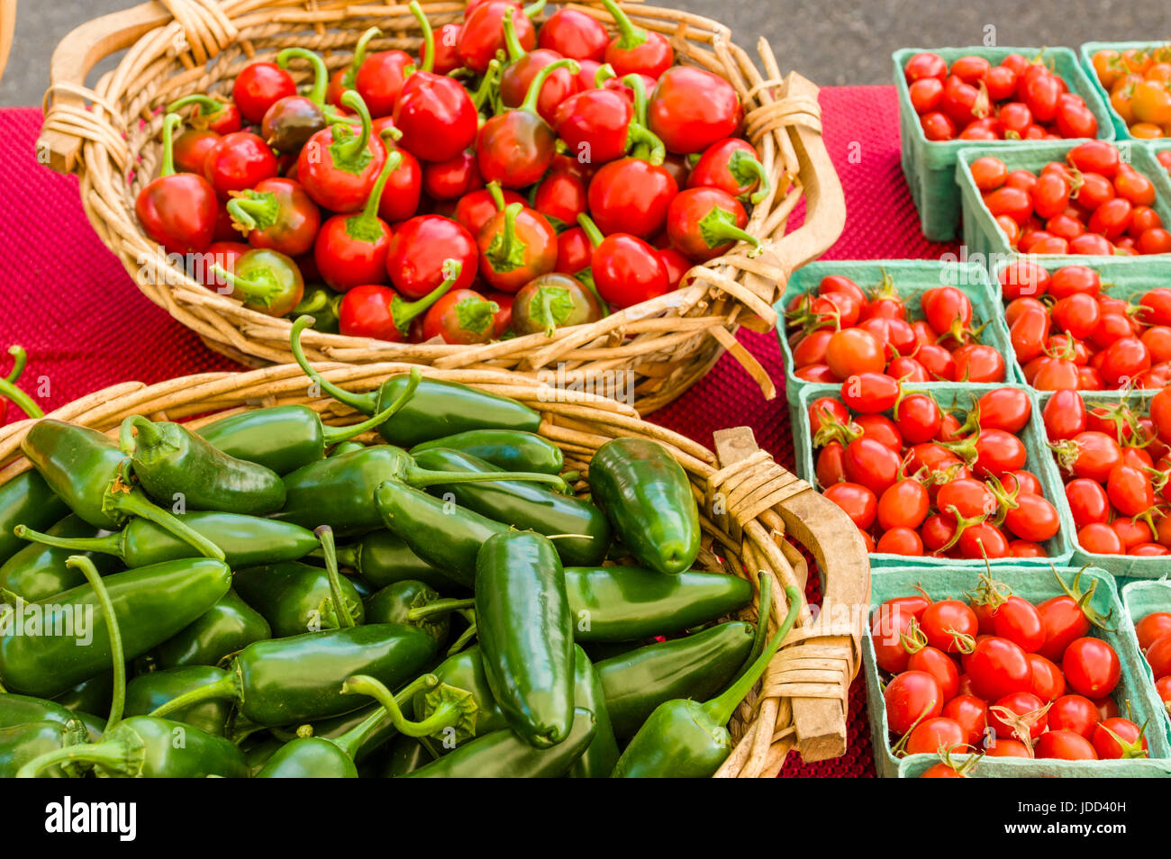 Baskets of hot peppers and cherry tomatoes at the market Stock Photo ...