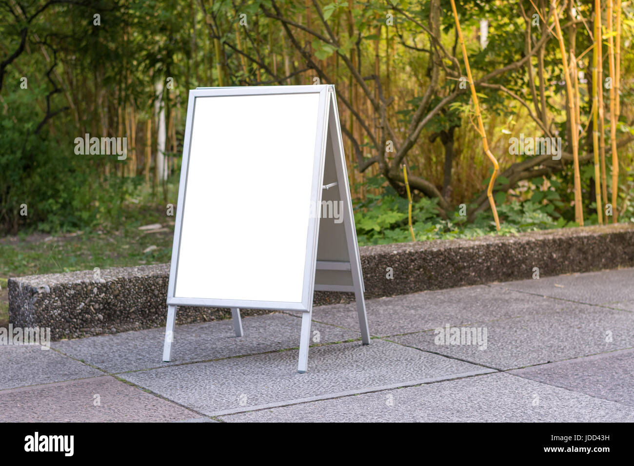 Blank ad space sign infront of trees in a park on the ground Stock ...