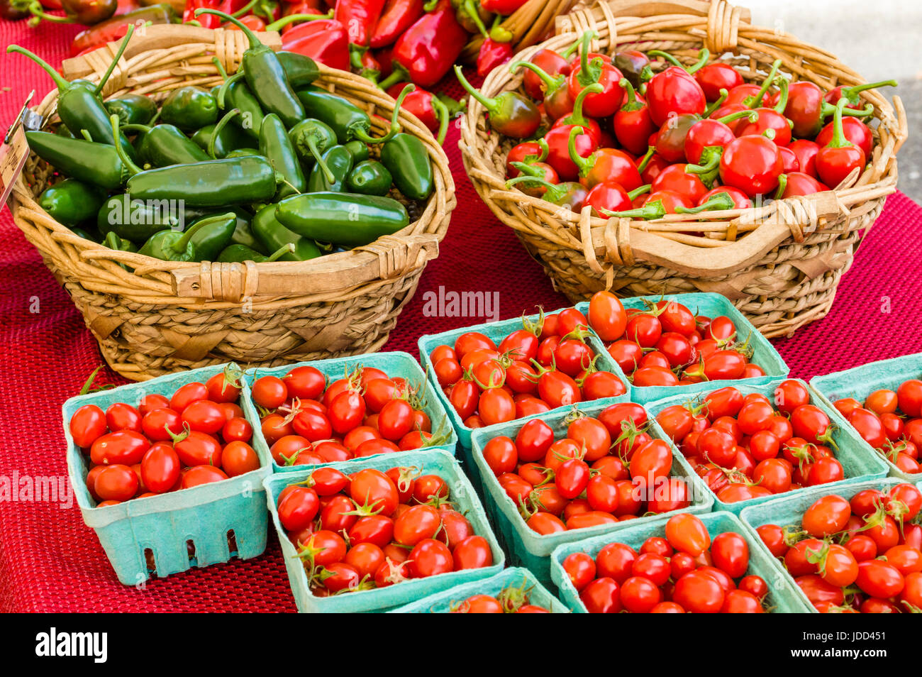 Baskets of hot peppers and cherry tomatoes at the market Stock Photo ...