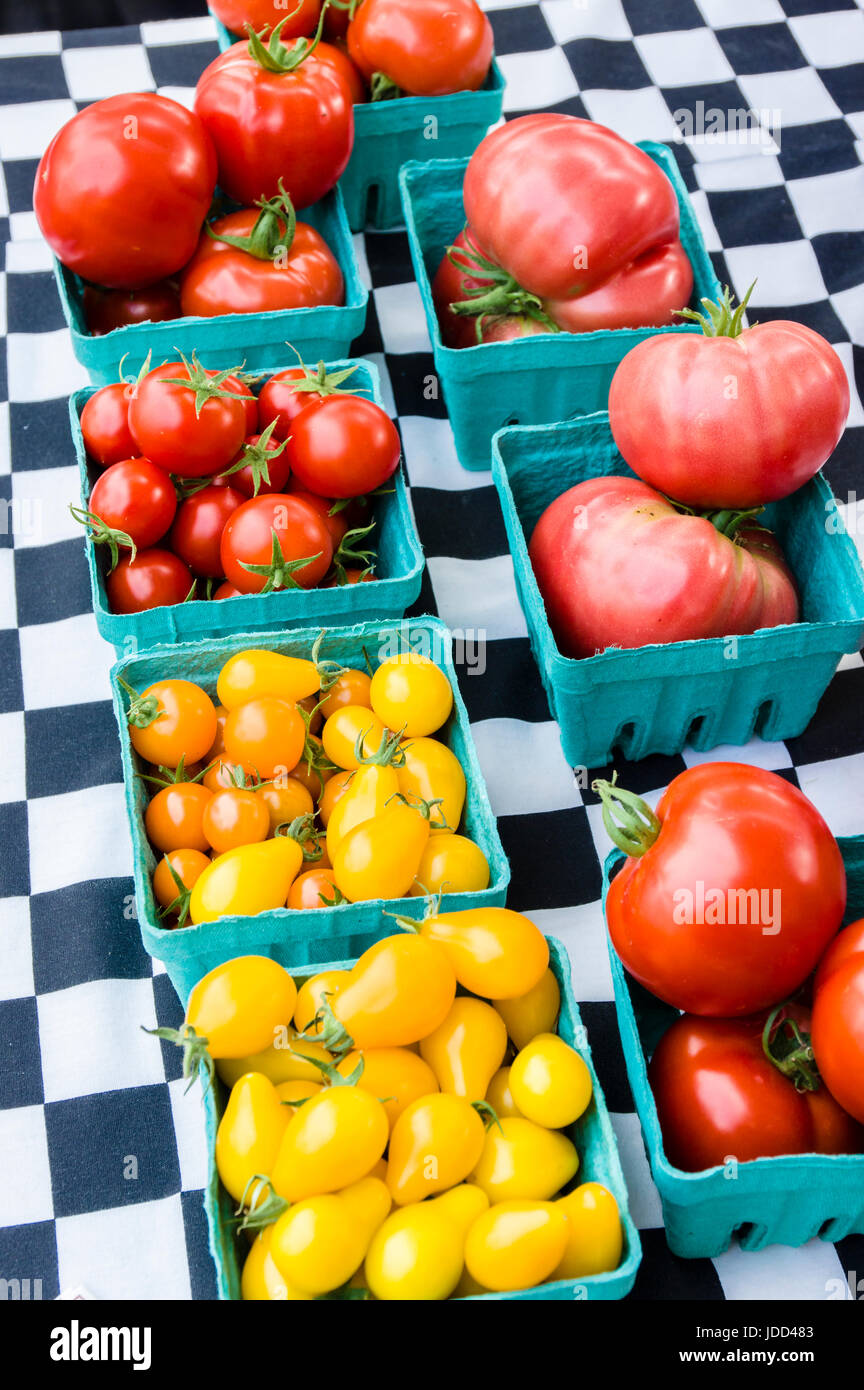 Display of pear and red tomatoes in boxes at the farm market Stock Photo