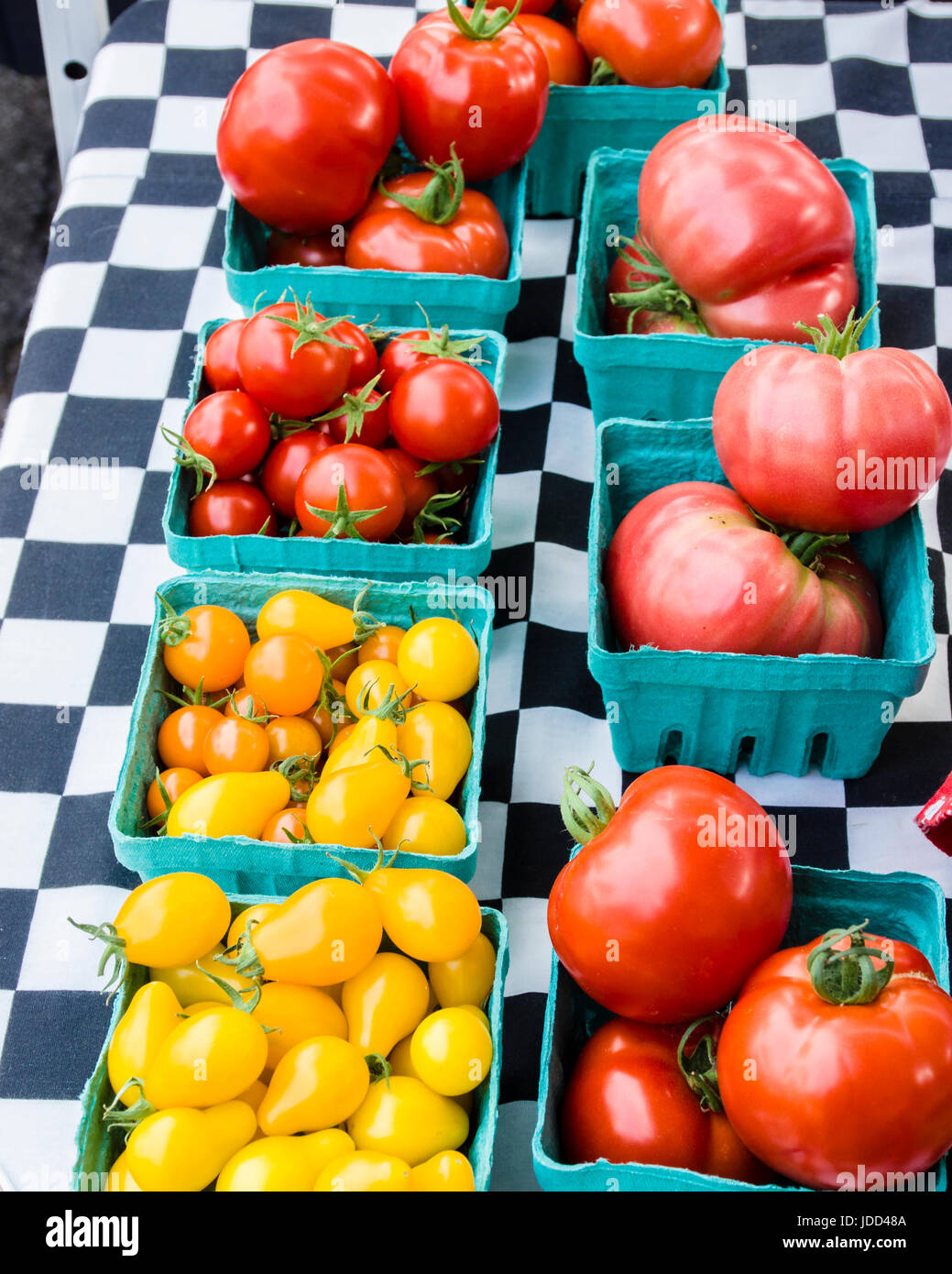 Display of pear and red tomatoes in boxes at the farm market Stock Photo