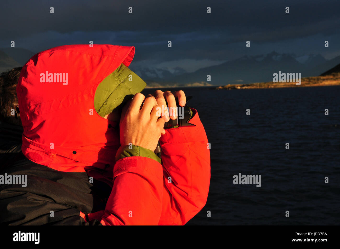 magic morning light, tourist takes a picture of rough patagonian landscape on a boat trip near Puerto Natales, Chile Stock Photo