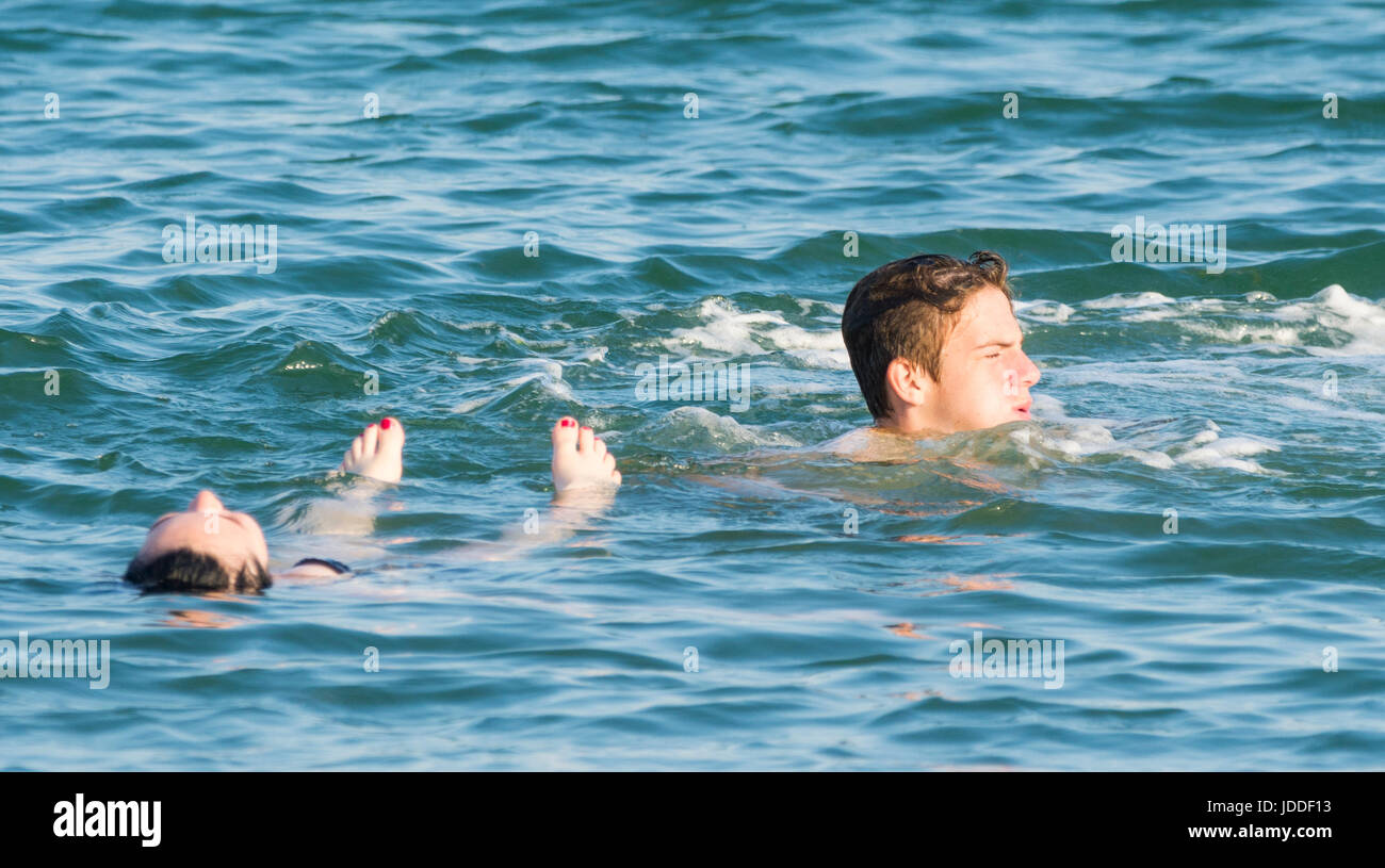 Young couple cooling off in the sea on a hot evening. Stock Photo