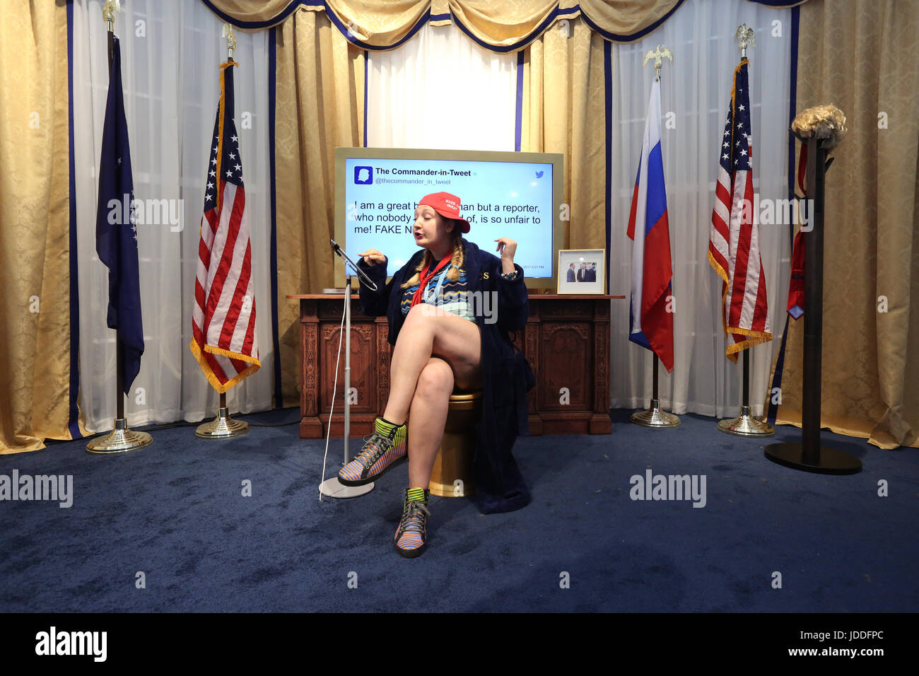 New York, USA. 18th Jun, 2017. Roxie Maisel interacts with a parody of the White House Oval Office at The Daily Show Donald J. Trump Presidential Twitter Library on West 57th Street in Manhattan during the last day of the three-day pop-up exhibit on Sunday June 18, 2017 in New York, USA. Credit: SEAN DRAKES/Alamy Live News Stock Photo